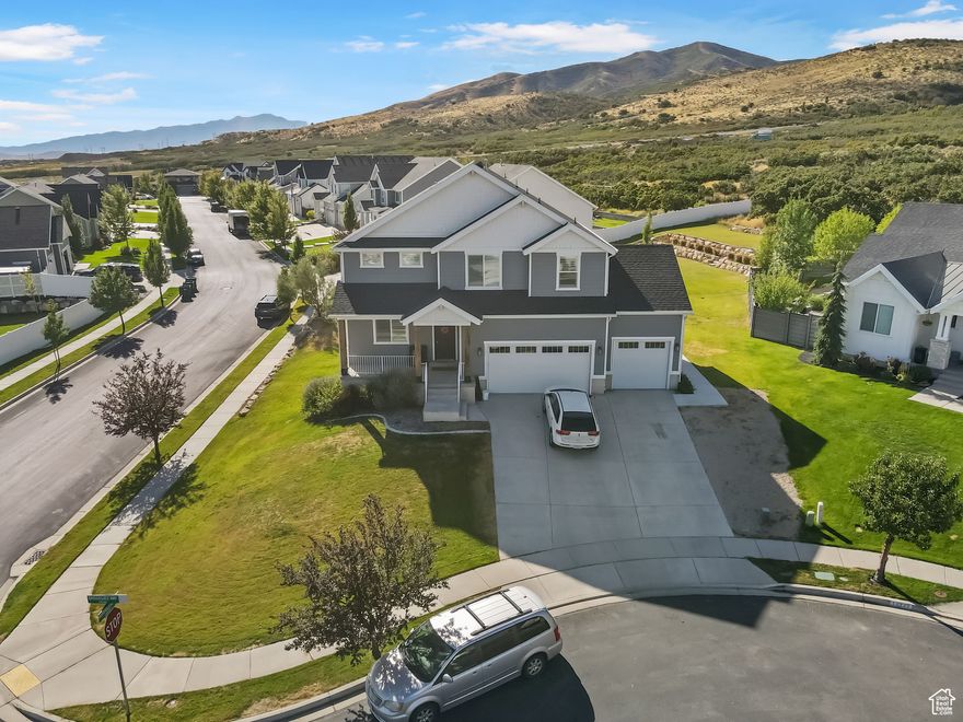 **This home will be featured on ABC4's Real Estate Essentials at 4:30pm this Sunday. Tune in and check it out!!** This stunning Craftsman-style home, located on a desirable corner lot in a quiet cul-de-sac within the award-winning Skye Estates community, offers breathtaking mountain and valley views. In addition to its beautiful design, the home features a fully functional basement apartment, making it a fantastic option for rental income or multi-generational living. The thoughtfully designed floor plan highlights an open concept layout with a gourmet kitchen featuring 3 cm quartz countertops, a double oven, custom cabinetry with a wood hood, and abundant natural light from an impressive 8' x 8' sliding glass door. The main floor also includes 8-foot doors throughout, and the dining room features a two-foot cantilever for added space and openness. The master suite is designed to impress, with a spa-like bath that includes an elongated soaking tub, ornate shower tile surround, and Euro glass enclosure. Built with 2" x 6" walls and a 96% efficient furnace, this home is both comfortable and energy efficient. The fully finished basement includes a separate entrance behind the third-car garage, a full kitchen, spacious bedroom, full bathroom, washer and dryer, and also has access to the private movie theater room. This home combines luxury, comfort, and efficiency in one of the most sought-after communities in the area.   Square footage figures are provided as a courtesy estimate only and were obtained from county records.  Buyer is advised to obtain an independent measurement.