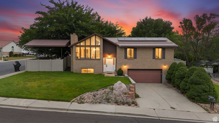 Welcome to your new home!  Located on a large corner lot with a beautiful private fenced yard and deck, perfect for BBQ's and get togethers.  Extra 15X15 covered parking or possible  boat or RV parking on side of home. Inside, the light filled living room features huge windows and a fireplace. The kitchen includes a new stove with convection oven and new microwave. Home is equipped with a metal roof, newer furnace, newer  50 gallon tank water heater, and a water softener. With 3 bedrooms, 2 baths on main floor and an additional bath and large family room in the basement, this well laid out home offers great potential in a wonderful neighborhood. Schedule a showing today! Home includes solar panels with a $15,000 balance due for Buyer to finance, call for more information. Buyer/Agent to verify all information including square footage.