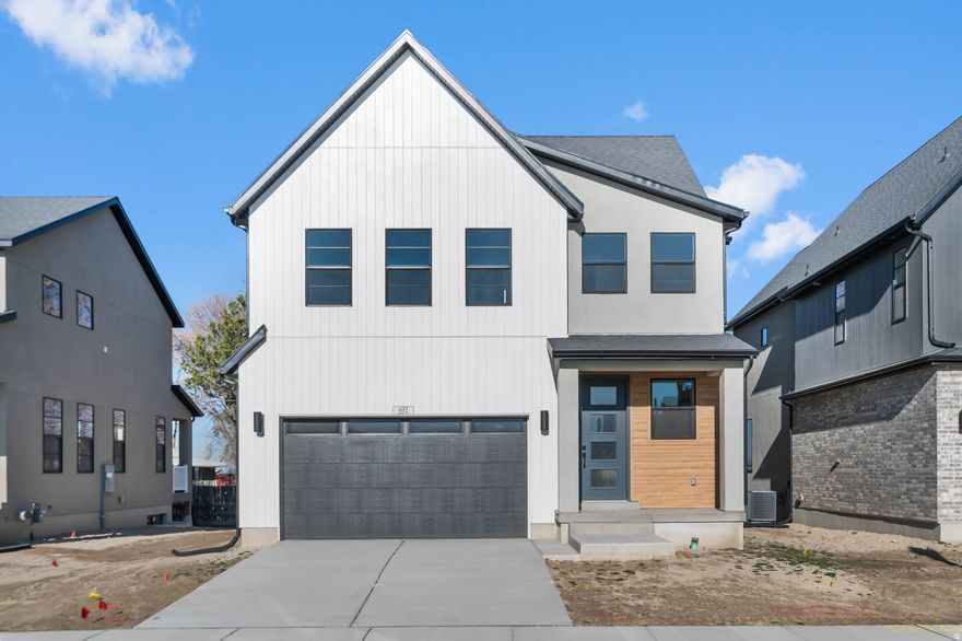 Come see this beautiful Kronborg floor in a great West Draper community! This home highlights a stunning kitchen with cotton maple cabinetry and quartz countertops, perfectly complemented by platinum gas appliances and tile backsplash. Enjoy the warmth of laminate hardwood flooring with tile and carpet in key living spaces. The home is enhanced with can lighting, Christmas light outlets, and energy-efficient options for year-round comfort and savings. A tankless water heater, metal stair railing, and 2-tone paint elevate the interior, while the large Craftsman base & casing provide designer appeal. The owner's bathroom features quartz shower surrounds and bold black matte hardware for a sleek, modern finish. Come check it out today!