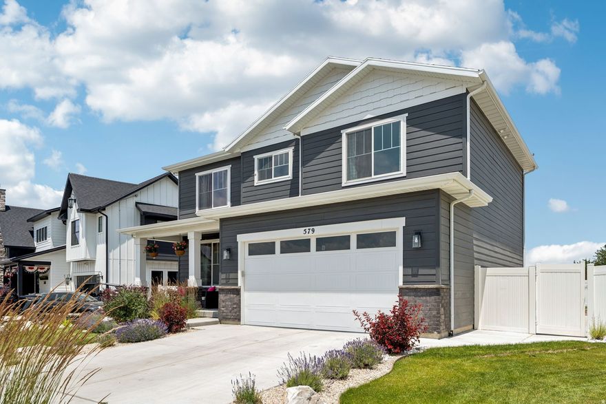 This is it-your dream home located in the highly sought-after England Ridge subdivision in Tooele! This home is truly magazine-worthy, filled with natural light and ready for you to move in and fall in love. It boasts updated lighting, window coverings and draperies, and rooms with custom, tasteful paint schemes. Upstairs, you'll find three spacious bedrooms, a true laundry room with cabinetry, and a flex space. The primary bedroom features a large walk-in closet and an en-suite bathroom with a double vanity and a spacious walk-in shower. The main level includes a cozy family room, a well-appointed kitchen with a large island, a dining space, a half bath, and a "hidden room" currently being used as an office. Large sliding doors open to the amazing backyard, complete with a large patio, a pergola with solar lighting, sidewalks, tasteful landscaping, and a gate that opens directly onto a walking trail-giving you private access from your own yard! Enjoy the added privacy of no backyard neighbors. The basement features a large family room, a full bathroom, and another bedroom. The two-car garage includes epoxy flooring, cabinetry, and a workbench. The location is ideal-close to shopping, gyms, and schools. Plus, you're just a stone's throw away from local parks, making it perfect for outdoor adventures. England Ridge is known for its tight-knit, friendly community where neighbors feel like family. Don't miss your chance to own this perfect home! Seller is willing to contribute $7500 towards buyers closing costs. Square footage figures are provided as a courtesy estimate only and were obtained from County Records. Buyer is advised to verify all information and obtain an independent measurement.