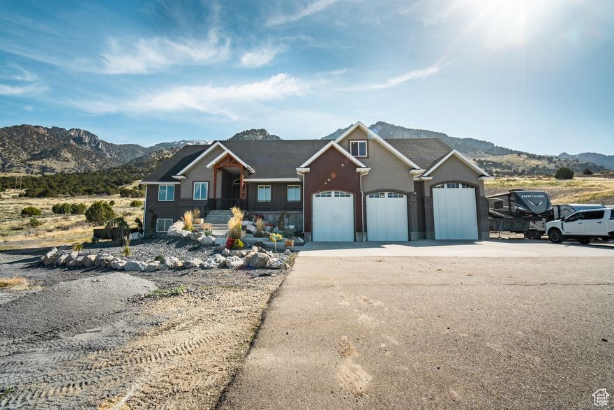 Nestled beneath the breathtaking cliffs of the Wellsville Mountains, this home is perfectly positioned to take in both sweeping valley views and dramatic mountain backdrops. Whether you're soaking in the scenery or enjoying the crisp mountain air, the setting invites you to linger outdoors. Inside, the open layout offers plenty of space for both entertaining and everyday living. This home features large windows throughout to capitalize on the beautiful views and abundant natural light. The custom kitchen features a generous island ideal for gathering and flows effortlessly into the main living areas. Step outside to a covered patio, perfect for relaxing on cool evenings. Primary Suite on the main level features separate walk-in closets, a soaker tub and spacious walk in shower. The fully finished basement provides ample room for long-term guests, hobbies, or additional living space and could easily function as a separate living area or ADU. Additional highlights include Garage with oversized 3rd bay door and extra depth to allow large trailer, boat, or RV parking, RV hookups with power and a convenient dump station. Come experience the beauty, comfort, and functionality this home has to offer! Buyer to verify all information.