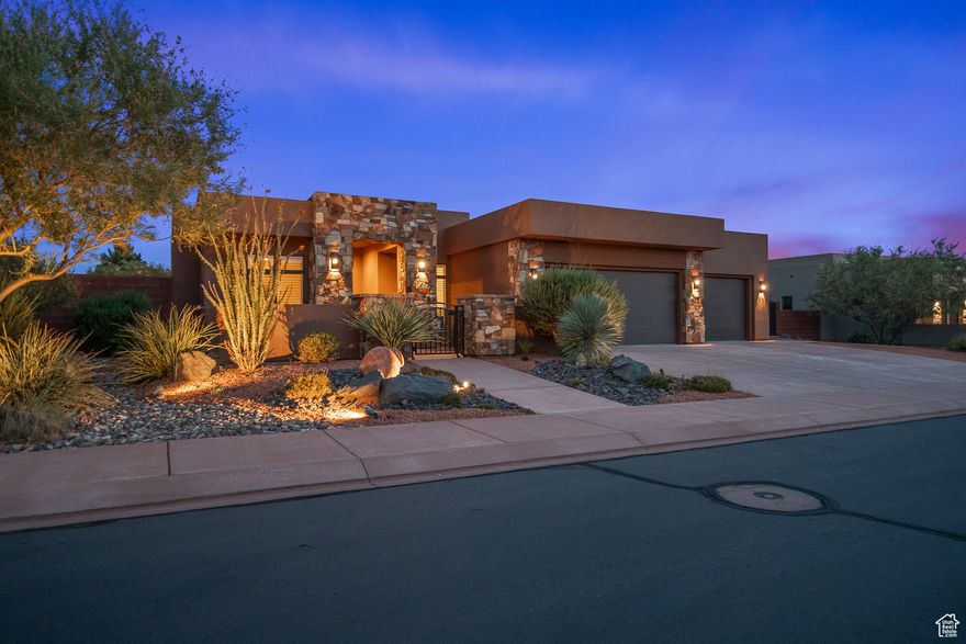 This truly beautiful and luxurious home offers quality and comfort inside and out, highlighted by expansive windows framing stunning views of Red Mountain, and an incredible private oversized backyard retreat. Crafted with solid, superior construction rarely found in today's builds, the home is filled with upgraded trim, finishes, and features throughout. Step inside to lofty ceilings, 10-foot plate with elevated heights of 11 feet in the kitchen, 12 feet in the entry, office, and great room, and soaring to 15 feet on the exterior. Beautiful faux-wood floor tile, decorative shower and backsplash tiles, quartz countertops, quality blinds and plantation shutters, high-end appliances with double ovens, gas range and custom hood, all reflect the attention to detail. The kitchen offers 2 walk-in pantries - storage is abundant throughout with well-designed closets, cabinets and nooks. A dual-zone HVAC system helps with heating and AC efficiency, and even the insulation is top-tier, with superior protection in external walls and interior sound walls thoughtfully built for comfort. The backyard is a showpiece of its own, offering tall covered patios with oversized columns and decorative trellis, a complete outdoor kitchen with grill, pizza oven, and cooking station, and a rooftop lounge accessed by an elegant circular staircase. Relax in the hot tub spa surrounded by attractive decking, or meander through flagstone walkways, manicured lawns, gardens, and peaceful sitting areas. Auto-accent lighting bathes the area in ambient light at night. Also, for the green thumb, there are vegetable garden boxes, and mature plum and pomegranate trees. RV parking w/full hook-ups rests behind custom iron-work gates.  Bonus spaces include a garage office and a decorative potting shed or hobby room, just a few of the countless extras that make this home truly exceptional.