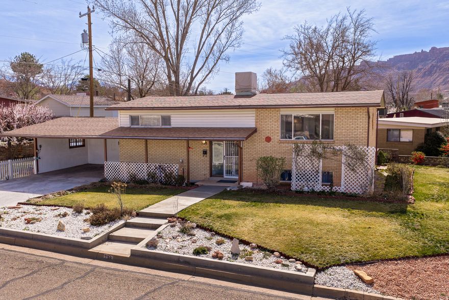 Rare 5-bedroom, 2-bath home located on a desirable corner lot in a downtown Moab neighborhood. This property features a new roof in 2022.  The well-maintained yard is beautifully landscaped with mature fruit trees and colorful flowers, creating a welcoming outdoor space to enjoy. With plenty of room for family, guests, or a home office, this home offers both comfort and functionality in a fantastic location.