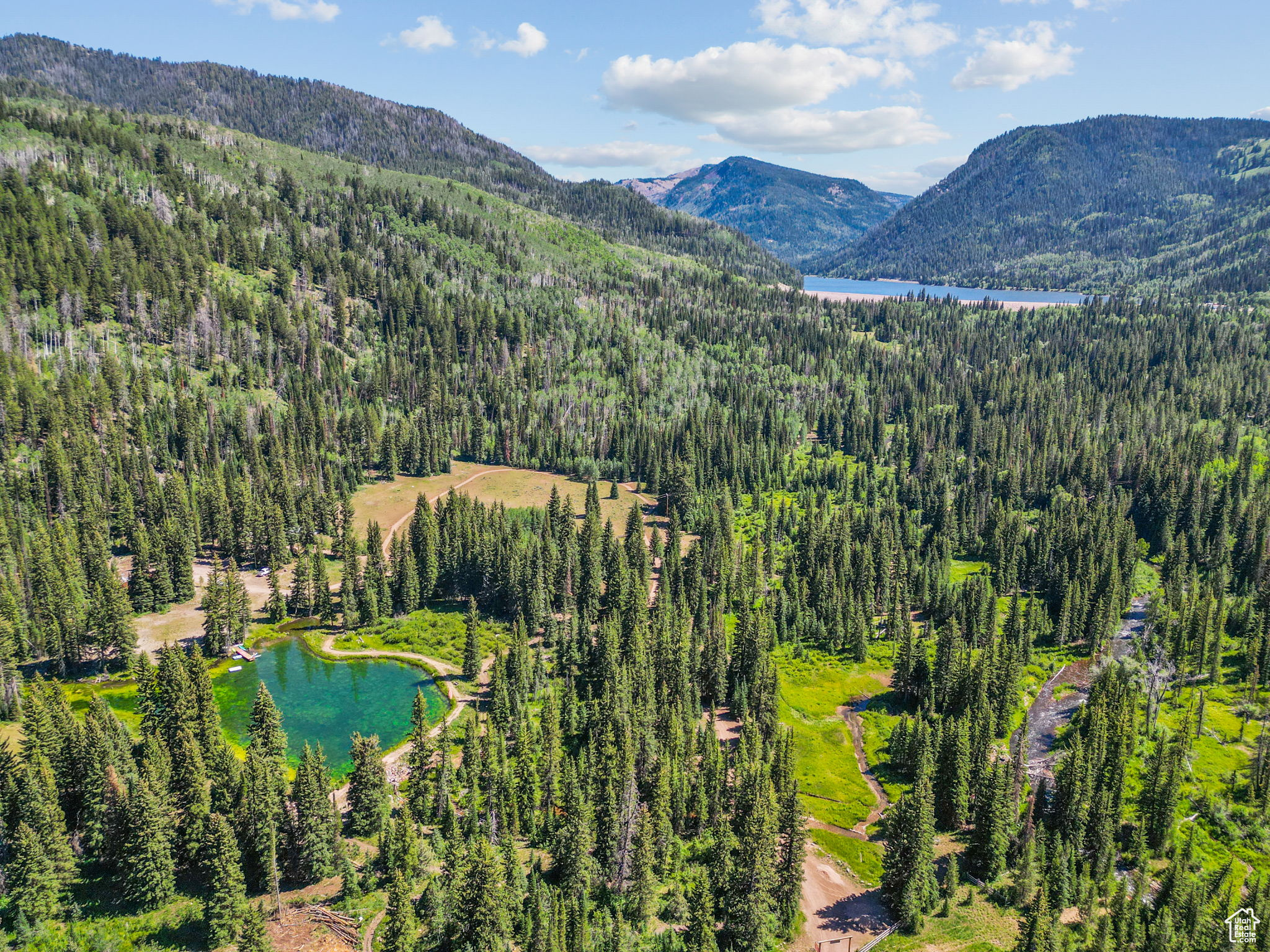 Escape to your own secluded wilderness paradise with this rare offering-two total lots comprising 25 pristine acres with a rustic cabin, plus an additional 0.66-acre buildable lot, sold together to create the ultimate mountain getaway. Tucked behind two private gates and bordering 2.2 million acres of National Forest near the breathtaking Smith & Morehouse Reservoir, this property offers unparalleled privacy, serenity, and natural beauty. With abundant wildlife and limitless potential, this is a true legacy property-an extraordinary, once-in-a-lifetime opportunity to own your own slice of alpine heaven.