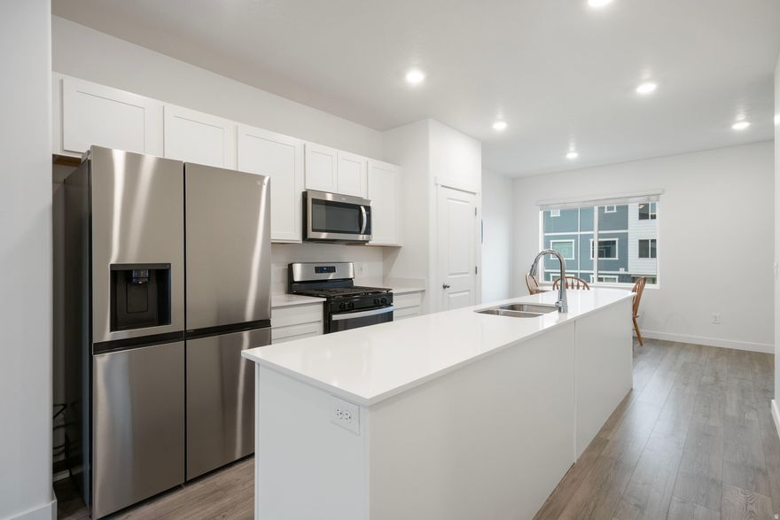 PRICE DROP! Open House Saturday, December 27th 11AM-1PM. Motivated seller, bring all offers. Immaculate townhome located on the Saratoga Springs/Lehi Border, North Shore community for quick access to I-15 or Redwood Road, only 2 years old! This home features Sandbar Park directly out the front door, a main-level bedroom and full bathroom. The main living area includes large windows and a kitchen centered around a spacious island. Upstairs, you will find two additional bedrooms with en-suite bathrooms and large closets. The community offers an array of amenities: pool, clubhouse, pickleball courts, a dog park, multiple parks, and easy access to walking trails. Move-in ready!