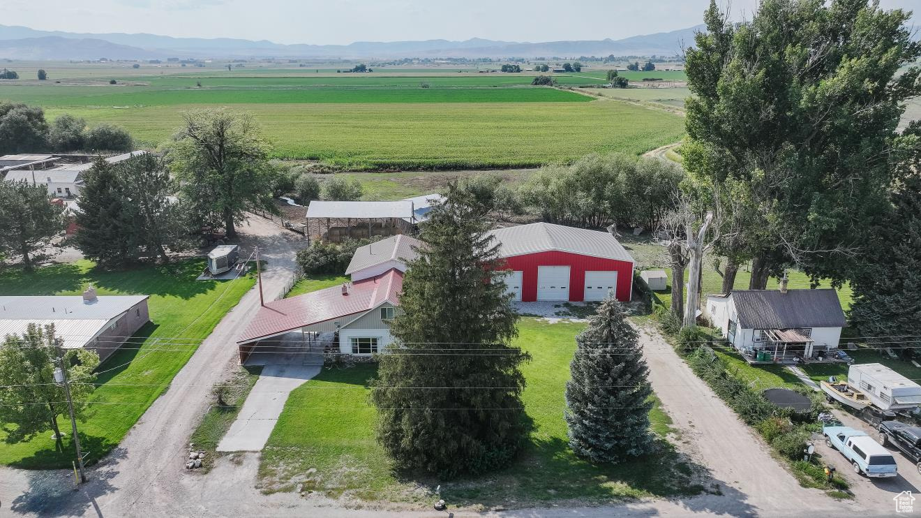 Discover the charm of this beautifully updated farmhouse featuring 5 bedrooms and 3 bathrooms, perfectly blending modern updates with classic character. The spacious layout offers a large family room with a cozy fireplace and an updated kitchen designed for both function and style. This home also features a massive covered patio to enjoy the cool, crisp fall evenings. You will also find a 40x60 insulated shop with heat providing endless possibilities for storage, hobbies, and parking. A rare find with plenty of comfort and versatility all in one property!