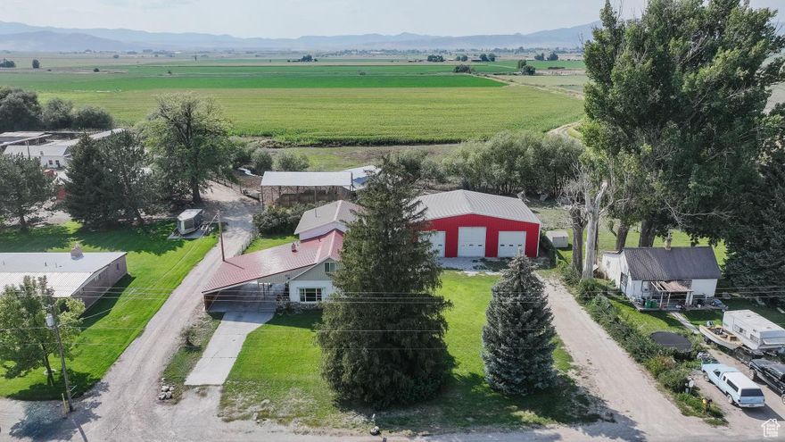Discover the charm of this beautifully updated farmhouse featuring 5 bedrooms and 3 bathrooms, perfectly blending modern updates with classic character. The spacious layout offers a large family room with a cozy fireplace and an updated kitchen designed for both function and style. This home also features a massive covered patio to enjoy the cool, crisp fall evenings. You will also find a 40x60 insulated shop with heat providing endless possibilities for storage, hobbies, and parking.  A rare find with plenty of comfort and versatility all in one property!