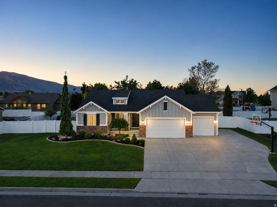 Located in one of Kaysville's most desirable neighborhoods, this Symphony-built home has been exceptionally maintained and reflects true pride of ownership throughout. Built by one of Utah's premier builders, the quality of construction and craftsmanship speaks for itself.  The exterior features a beautifully manicured yard with mature landscaping, garden boxes, RV parking, and a quiet, established setting.  Inside, vaulted ceilings and plantation shutters create a bright, open feel. The kitchen is designed for both everyday living and entertaining, featuring a massive island, stainless steel appliances, and excellent flow into the main living spaces.  The main-floor family room includes a gas fireplace, while the spacious primary suite offers a large walk-in closet along with a separate tub and shower.  Downstairs, the expansive basement provides incredible flexibility for a theater room, gym, game room, or additional living space, along with abundant storage in both the fruit room and garage areas.  The oversized third-car garage is extra deep and finished with epoxy floors, offering ample room for vehicles, storage, toys, or workspace.  Homes with this level of care, functionality, and build quality rarely come available in this area.