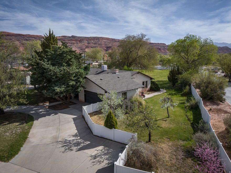 OPPORTUNITY AWAITS! Set on nearly an acre on Moab's sought-after westside, this property offers space, setting, and unmatched potential. With 4 bedrooms, 2 baths, and 1,621 square feet, the existing home is a canvas ready for your vision, while the expansive landscaped yard invites endless possibilities, outdoor entertaining, creative landscaping, or future expansion into a small subdivision within the R2 zoning.  Seller is willing to assist with flooring upgrades. Just minutes from downtown, Swanny City Park, and the Moab Recreation & Aquatic Center, this is where convenience, lifestyle, and opportunity converge in one of Moab's most desirable areas. Whether you're imagining your dream home, a thoughtful redesign, or a smart investment, this property provides the foundation to create something truly exceptional.  Square footage figures are provided as a courtesy estimate only and were obtained from images.  Buyer is advised to obtain an independent measurement.