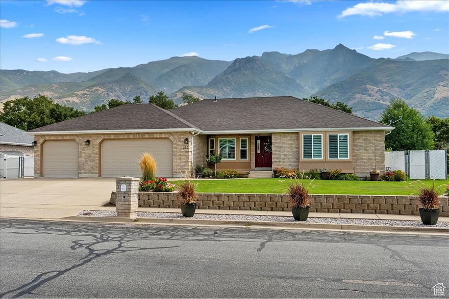 Welcome home to this beautifully maintained 5-bedroom, 4-bath East Layton rambler tucked against the Wasatch mountains. Step inside to an updated kitchen featuring abundant cabinets, under-cabinet lighting, granite countertops, pendant lighting, a large island, and even a built-in desk. The dining nook with a picture window flows into the vaulted family room with a cozy fireplace and access to the large, secluded, covered patio-perfect for relaxing and entertaining. The primary suite offers a spacious retreat with a walk-in closet, double sinks, and a large shower. Two additional bedrooms and a full bath, along with a formal living room and open entry, complete the main floor. The fully finished basement is designed for gatherings and flexibility, boasting a separate TV room, game area, full kitchen, two more bedrooms, and another full bath, plus generous storage and shelving. A half bath off the garage entrance, a large 3-car garage with an extra-long bay, workbench, and overhead storage, plus RV parking, making room for all your toys. Outside, enjoy a fully fenced yard to keep your pets contained, immaculately landscaping that shows true pride of ownership. Water heater, rain gutters, and windows new in last few years. Roof, Furnace, and AC replaced in last 10 years. All this in a prime location-just minutes to HAFB, Hwy 89, shopping, dining, lakes, and world-class ski resorts, and only 20 minutes to SLC Airport. Don't miss your chance to own this East Layton gem! Schedule your private showing today-this one won't last!