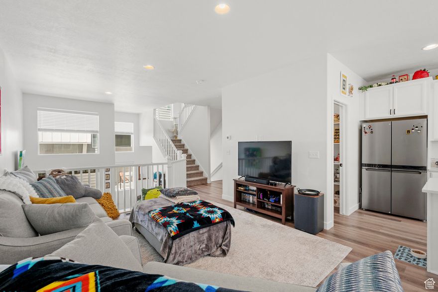 Step into comfort and function with this beautifully designed home featuring a spacious open-concept living area, soaring ceilings, and abundant natural light. The large kitchen and living room flow seamlessly, perfect for everyday living and effortless entertaining. The primary suite boasts a luxurious walk-in shower with dual shower heads, and the layout is ideal for hosting-with an expansive island and generous parking options.  Enjoy unmatched access to nature with paved and dirt trails, the Jordan River Parkway, and parks-including food trucks, pickleball courts, and more-just a short walk away. Conveniently located minutes from I-15, with shopping and dining nearby, this home truly captures Bluffdale's "Life Connected" motto.