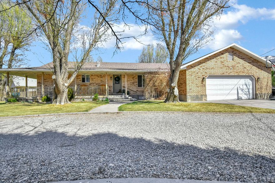 Welcome to this beautiful 5-bedroom, 3-bathroom home in the heart of Monroe, where breathtaking mountain views and the charm of small-town living come together. Situated on a spacious .53-acre lot, the property features a gorgeous yard with mature shade trees, blooming rose bushes, fully fenced for privacy and security, and valuable irrigation water, making it easy to keep the landscape lush and green. Inside, you'll find 3,348 square feet of comfortable living space with large rooms and a functional layout designed for everyday living. The home offers a spacious pantry with plenty of storage and a huge garage perfect for vehicles, hobbies, or projects. A separate basement entrance adds flexibility for guests, additional living space, or potential rental opportunities. Step outside to enjoy the large deck, perfect for relaxing, entertaining, or taking in the beautiful mountain views and peaceful surroundings. A brand-new roof has already been installed, providing added peace of mind for the next owner. With generous space inside and out, beautiful surroundings, and a prime location in Monroe, this property is the perfect place to enjoy peaceful small-town living while still being close to everything the area has to offer.