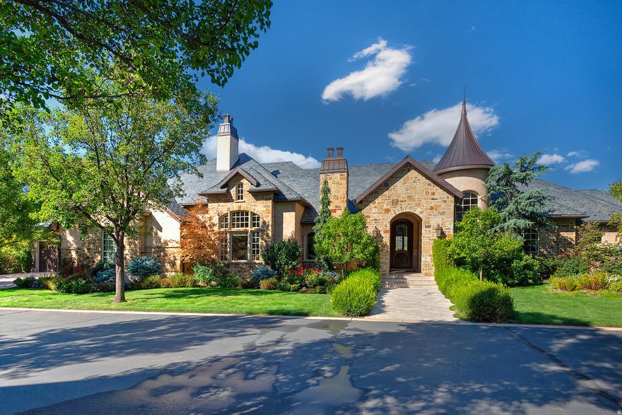 Step inside to the timeless elegance of this magnificent European-style estate, gracefully situated within one of Holladay's coveted gated communities. This distinctive architectural masterpiece is appointed with a generous five-car garage, a private elevator for effortless access, and a gracious entryway that truly promotes sophisticated living. Inside, two opulent master suites are linked by a hallway adorned with Crema Marfil marble, while the awe-inspiring two-story family room, featuring spectacular exposed beams and vast windows, flows seamlessly into a gourmet kitchen. The kitchen boasts Two Double Side by Side Fridges with Custom Cabinetry and Two Dishwashers. The lower level presents three additional bedroom suites, a relaxing sauna, a shower, and a dedicated, state-of-the-art theater room for optimal entertainment. Wander outside to a serene, covered deck overlooking a vibrant garden area complete with stately mature trees, exquisite colorful shrubs, and soothing tranquil waterfall. Enjoy peace of mind with a Backup Generator. With its updated, move-in ready condition and prime location just minutes from the 215 freeway, downtown, and ski resorts, this enchanting residence is a true must-see! Square footage is provided as a courtesy only. Buyer is advised to obtain an independent measurement and to verify all information.