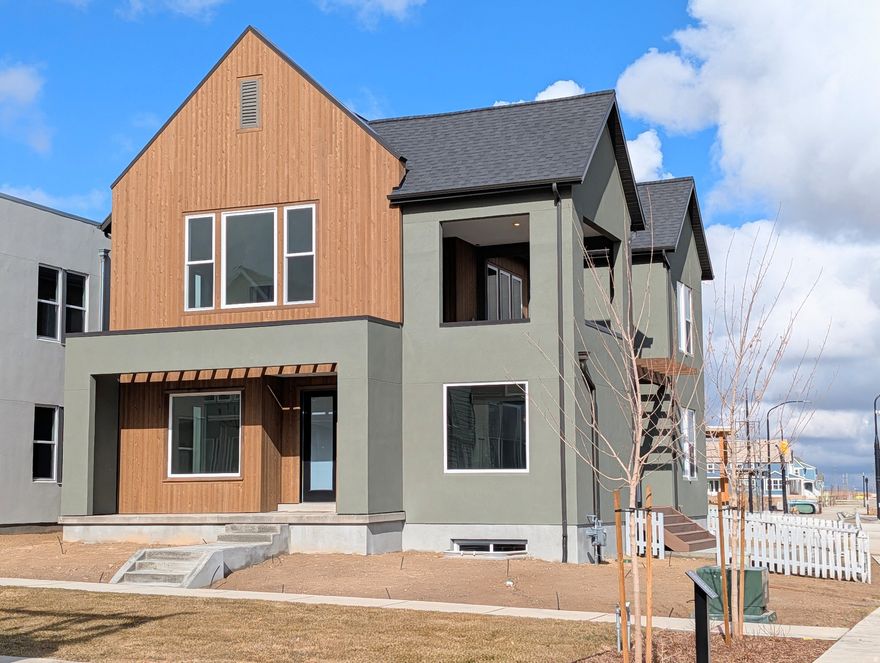 Move-In Ready, Brand New Home with the striking new cedar wood exterior! Enjoy stunning views from the many outdoor areas in this popular Adventurer floor plan! Price includes impressive designer upgrades such as: 9-foot ceilings on all levels, A cozy fireplace, modern railing, coveted indoor/outdoor living layout with oversized sliding glass doors connecting the Great Room and Kitchen with outdoor patio space. The main-level office is filled with natural light thanks to abundant windows perfect for work or relaxation. Upstairs, the dreamy Primary Suite features its own covered, hot tub-ready balcony, along with a luxurious en-suite bathroom complete with a stand-alone soaking tub and a spacious walk-in shower. Full landscaping and a fenced side/backyard. Photos are of actual home.