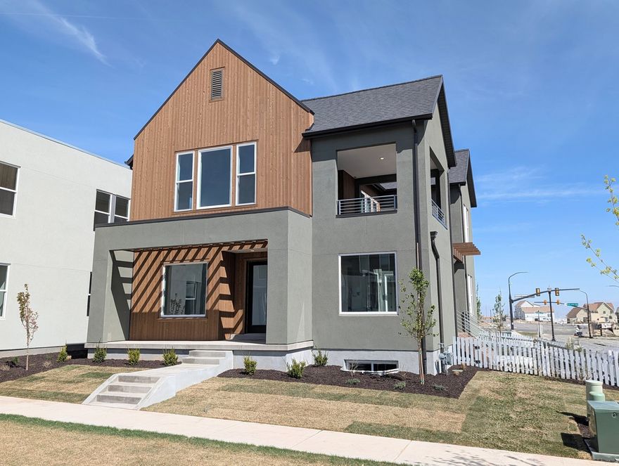 Move-In Ready, Brand New Home with the striking new cedar wood exterior! Enjoy stunning views from the many outdoor areas in this popular Adventurer floor plan! Price includes impressive designer upgrades such as: 9-foot ceilings on all levels, A cozy fireplace, modern railing, coveted indoor/outdoor living layout with oversized sliding glass doors connecting the Great Room and Kitchen with outdoor patio space. The main-level office is filled with natural light thanks to abundant windows perfect for work or relaxation. Upstairs, the dreamy Primary Suite features its own covered, hot tub-ready balcony, along with a luxurious en-suite bathroom complete with a stand-alone soaking tub and a spacious walk-in shower. Full landscaping and a fenced side/backyard. Photos are of actual home.