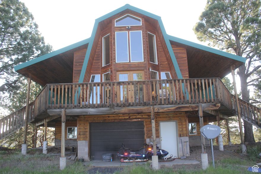 Lovely mountain cabin with beautiful views! Multiple decks. 3 bedroom 3 bath with garage in basement and an additional partially finished 3000 sq ft detached garage/workshop with living quarters. Cabin has a 10,000 gallon water tank and water shares in a community well.