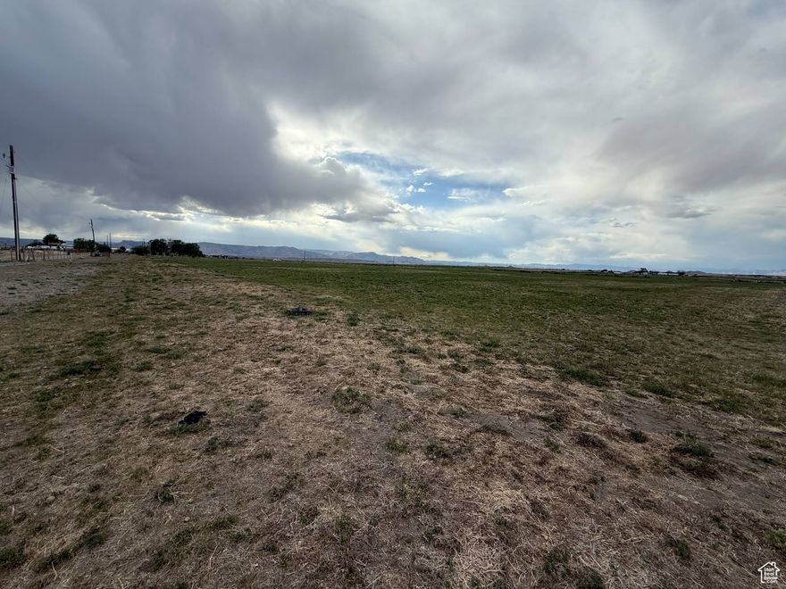 It's not every day that a farmer transforms productive alfalfa fields into a residential building lot-making this a rare opportunity! Located in peaceful Elmo, Utah, this lot is surrounded by beautiful mountain views and offers the privacy of no close neighbors. Zoned with animal rights and still capable of producing income as an alfalfa field, this property is ideal for those seeking space, serenity, and potential. Buyers looking to secure land now and build in the future-ask about financing options such as "lot loans" or "land loans" that may be available through select banks. If Buyer takes the property out of greenbelt they will be responsible to pay the green belt back taxes. Once their is an accepted offer the Buyer will be responsible to apply for greenbelt. List price is based off of recent appraisal.  Seller will seller finance. Square footage figures are provided as a courtesy estimate only and were obtained from Emery County .  Buyer is advised to obtain an independent measurement.