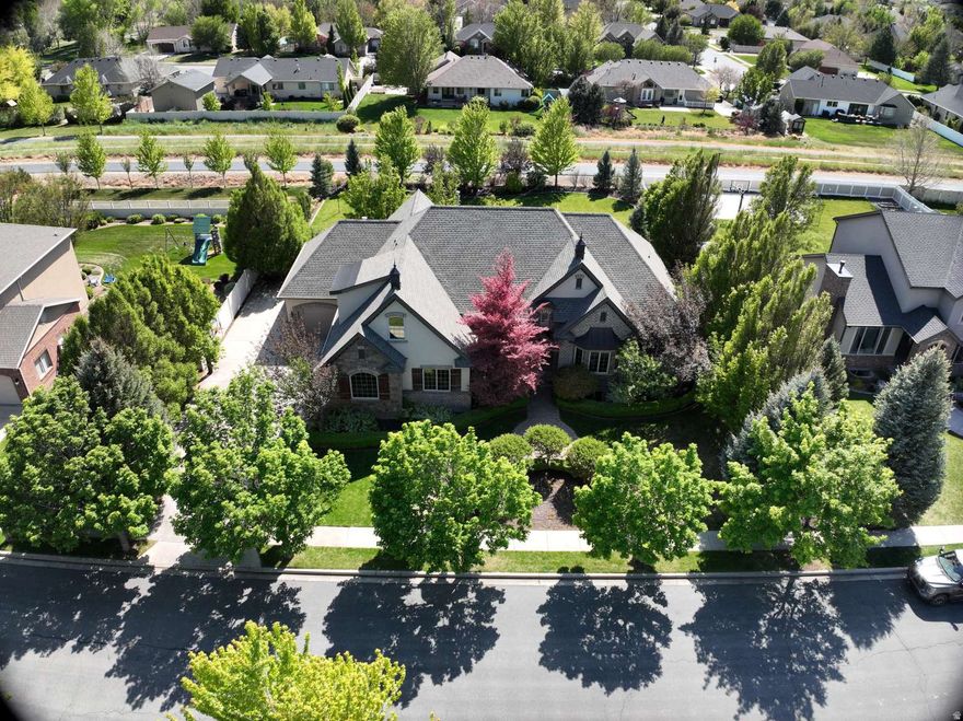 Nestled in the heart of Highland, this extraordinary custom estate at 6649 W Avery Ave. blends timeless European-inspired architecture with elevated modern living on a beautifully landscaped lot. From the striking stone-and-brick exterior and mature trees to the refined interior finishes, every detail has been thoughtfully curated for luxury, comfort, and style. Step inside to soaring ceilings, abundant natural light, wide-plank hardwood floors, and designer touches throughout. The stunning chef's kitchen is the centerpiece of the home, featuring an oversized quartzite island, professional-grade appliances, custom cabinetry, floating shelves, and elegant statement lighting. In 2023 and 2024 the house underwent a major remodel to the kitchen, master suite, back windows, basement and new garage doors. A new roof and tankless water heater was installed in 2025. The house has a 3 car garage with RV Parking. The house is available for immediate move in.