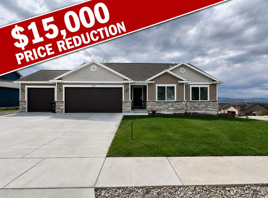 Huge Price Reduction!!  Beautiful east bench home offering breathtaking valley views and stunning sunsets from the spacious covered deck. The welcoming front porch showcases magnificent mountain views, creating a peaceful outdoor retreat. Inside, you'll find an open-concept layout with 3 bedrooms and 3 bathrooms on the main level, designed for both comfort and functionality.  The oversized 3-car garage is well-equipped with an EV charging outlet, utility sink, water softener, and convenient USB outlets. Thoughtful upgrades throughout the home include soundproof walls between bedrooms and between the primary suite and living room for added privacy.  The unfinished basement provides excellent potential for future expansion, already stubbed with gas lines for a range and laundry, along with plumbing for bathrooms and additional living space. Additional features include CAT6 wiring throughout, reinforced high-mounted TV outlets in the primary bedroom and living room, built-in stair lighting, and heat cables on the roof and in the garage with a dedicated circuit. The backyard is fully lit for evening enjoyment, and a cold storage room offers valuable extra space. Both the stove and dryer are plumbed for gas and electric, providing added flexibility.  Square footage figures are provided as a courtesy estimate only and were obtained from county records. Buyer is advised to obtain an independent measurement.