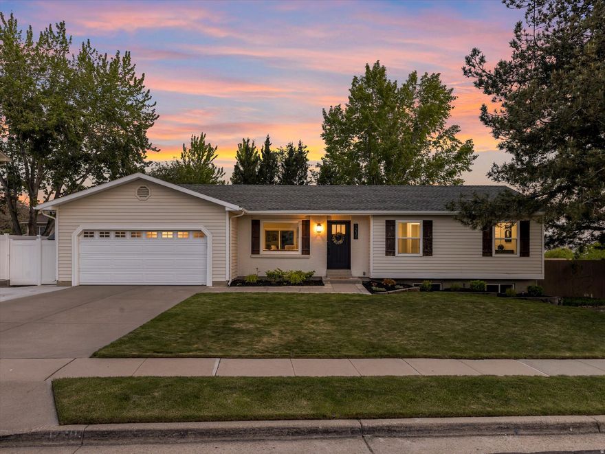 Beautifully remodeled rambler in one of East Sandy's most desirable neighborhoods, ideally located near top-rated schools, shopping, dining, trails, and parks. Exceptional curb appeal sets the tone, with a newly updated exterior and meticulously maintained landscaping that creates a warm and inviting first impression. This move-in-ready home has been thoughtfully upgraded throughout, featuring new carpet, recessed lighting, fresh interior paint, a sleek new stair railing, and durable luxury vinyl plank flooring across the main level. At the heart of the home is an expansive gourmet kitchen designed for both entertaining and everyday living. Highlights include granite countertops, custom cabinetry, generous counter seating, a gas range with a wood-clad hood, double ovens, and a sunny window framing beautiful mountain views. The adjacent dining area opens directly to a private patio, a perfect space to relax or entertain while enjoying sweeping mountain and valley views. The well-planned main level offers three bedrooms, two full bathrooms, a comfortable living room, and a functional laundry room with a sink. The spacious, ADA-accessible primary suite provides privacy and convenience, complete with a modern, spa-inspired bathroom and a no-step shower. The daylight lower level is filled with natural light and features a large bedroom, an oversized recreation room with a gas fireplace, a full bathroom, and a storage area. Major system upgrades have been completed including a new furnace, new air conditioning, and newer windows to ensure year-round comfort and peace of mind. Outdoors, the fully fenced backyard is perfect for relaxing, gardening, and play, with a lush lawn, two storage sheds, and a sprinkler system. This coveted East Sandy location offers quick access to renowned recreation trails in Sandy and Draper, as well as world-class skiing in Little and Big Cottonwood Canyons. Whether enjoying quiet evenings at home, hosting gatherings, or heading to the slopes, this home delivers exceptional comfort, style, and lifestyle appeal.