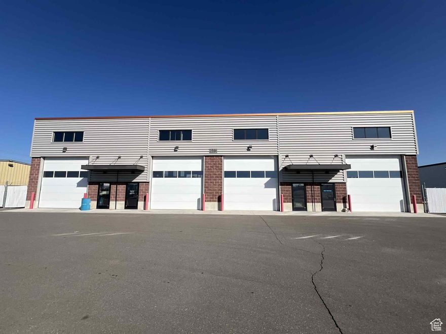 Available for lease is an approximately 2,000 square foot space located in a property zoned Ogden City OCIP and certified within the Ogden City HUBZone. This versatile facility features a large, open warehouse area with ceiling heights ranging from 20 to 23 feet, ensuring ample vertical clearance for various operational needs. The space is enhanced by lots of natural light and includes a small front office area for administrative use. Convenient access is provided by two 14' H by 14'  W overhead doors in front and rear, making loading and unloading efficient. Additionally, tenants benefit from a spacious 2,725 square foot secure fenced storage yard, ideal for additional outdoor storage requirements. The property is strategically situated close to the freeway and major roads, offering excellent connectivity and accessibility for businesses seeking a well-equipped, flexible location in Ogden.