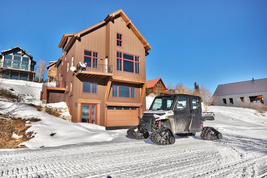 Experience unparalleled ski-in/ski-out access and breathtaking vistas at Powder Mountain Ski Resort. This elegant mountain modern cabin serves as an ideal base for immersing oneself in the full spectrum of Powder Mountain's offerings. Renowned globally for its uncrowded slopes and abundant fresh powder during winter, the property also provides direct access to miles of hiking and biking trails for summer exploration, establishing a year-round recreational haven. Featuring four bedrooms, four bathrooms, and an expansive entertaining area complete with a custom floating fireplace, this residence offers ample space for hosting family and guests.