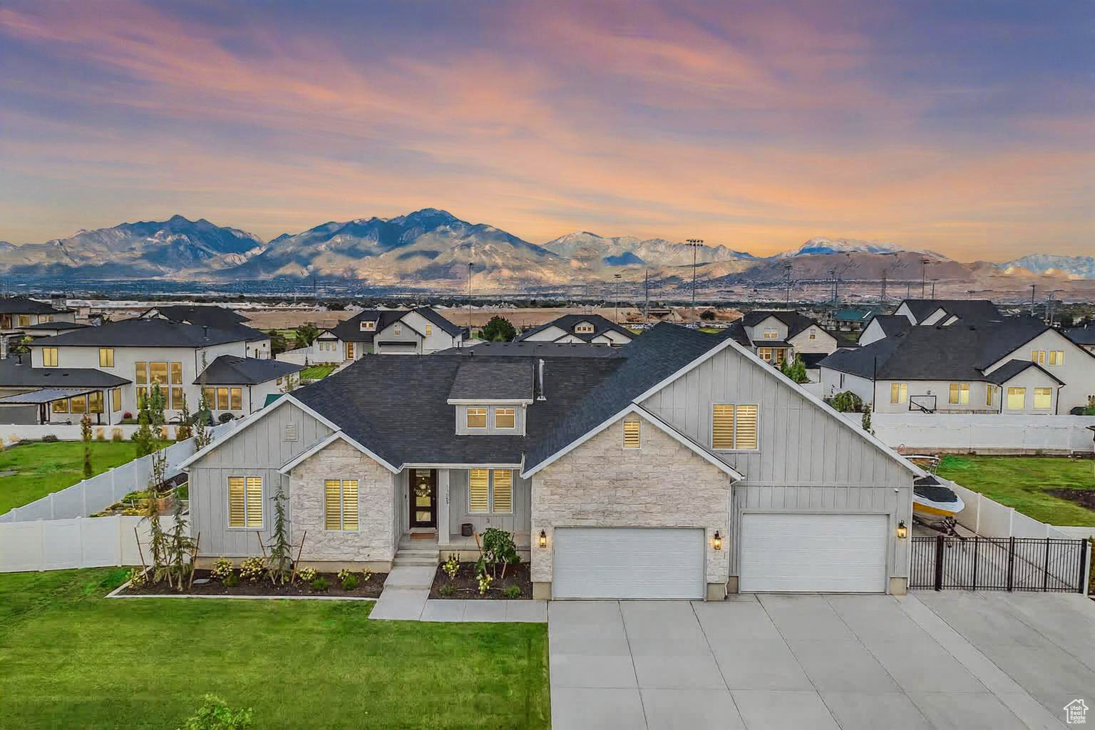 This professionally designed 7-bedroom, 5-bath, 3-family room home combines high-end finishes with thoughtful functionality. The open-concept main level features a huge kitchen with a walk-in pantry, seamlessly flowing into the living and dining areas-perfect for entertaining. The large master suite boasts a luxurious en suite bath, while the oversized laundry room and home office add everyday practicality. The fully finished basement includes a second full kitchen, a mother-in-law apartment, and an additional laundry room, making it ideal for extended family or guests. The spacious 6-car garage-40' deep-offers ample room for vehicles, storage, or a workshop, complemented by RV parking for added convenience. Step outside to a covered deck with an outdoor kitchen featuring a grill, fridge, pizza oven, and Blackstone grill. Enjoy the outdoor firepit, large play set, and planter boxes-all designed for year-round enjoyment. Located close to shopping, dining, and entertainment, this property is perfect for families or anyone who loves to host.