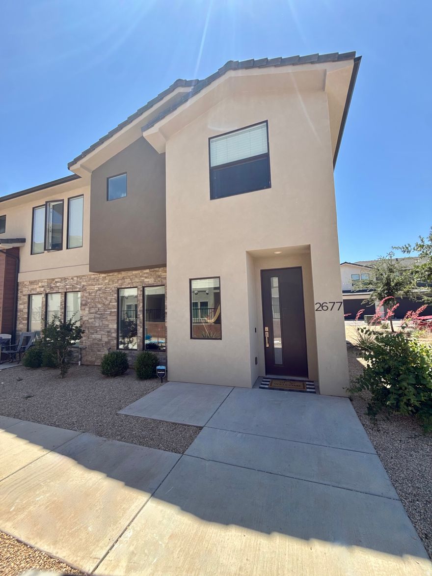 Beautiful end-unit townhome in the highly desirable Woodland Estates community! This immaculate 3 bedroom, 2.5 bathroom home features an open and functional floor plan with 9-foot ceilings that make the space feel bright and spacious throughout. The main level offers a comfortable living area, stylish kitchen with ample counter space, dining area, and convenient half bath--perfect for everyday living and entertaining. Upstairs, you'll find generously sized bedrooms, full bathrooms, and a stunning primary suite complete with a walk-in closet. Enjoy resort-style HOA amenities including a pool, lazy river, hot tub, pickleball courts, parks, and playgrounds. Ideally located just off Mall Drive near Dino Crossing, Lin's Market, Revere Health, schools, shopping, dining, and more. This move-in ready end unit combines comfort, convenience, and an incredible lifestyle opportunity! Smart TV in upstairs owners suit also included.  Square footage figures are provided as a courtesy estimate only and were obtained from the county.  Buyer is advised to obtain an independent measurement.