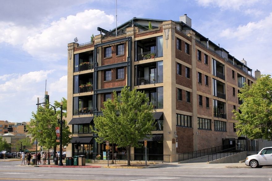 Not all "lofts" are created equal. Dakota is the real deal-an iconic 1923 brick building converted in 1997 with honest materials you can feel the second you walk in: cement floors+columns, exposed ductwork, track lighting, brick and tall concrete ceilings. And then there is the historical detail from the past, the original yellow factory stripes running across the floor. The space lives open and intentional: a true one bedroom plus a bonus enclave that can flex into studio space, library or guest zone. Concrete countertops paired with premium cabinetry give the kitchen a clean, modern edge. Cabinets in kitchen and bath were designed specifically for this space. Seller has installed double panes on the historic windows. Parking in the lower parking garage. Secure storage in the basement of the building.
