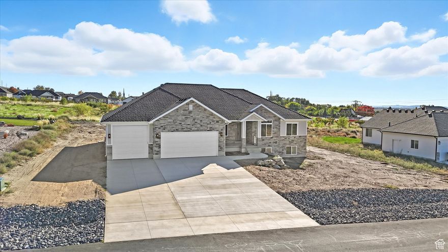 **OPEN HOUSE Sat. 12/6 - 10AM -1PM** Price reduced!! Your brand new custom dream home awaits  MOVE-IN READY! This stunning rambler is thoughtfully designed for main-level living, featuring 3 spacious bedrooms plus a den on the main floor, with 2 additional bedrooms in the walkout basement below - perfect for an ADU or mother-in-law suite. Situated on a flat .45-acre lot, you'll love the peaceful country feel paired with unbeatable convenience. The location offers easy freeway access, making it just as convenient to reach as the Plain City and North Ogden areas. Enjoy breathtaking mountain and Willard Bay views and unforgettable sunsets from the large covered deck. The open-concept great room centers around a cozy gas fireplace, while the gourmet kitchen features hardwood cabinetry, granite countertops, a large island, walk-in pantry, and a spacious dining area surrounded by windows. The luxurious primary suite includes a spa-style shower, dual sinks, and a generous walk-in closet. Main-floor laundry and an oversized, insulated, and painted 4-car garage. This home perfectly blends luxury, comfort, functionality and convenience - your dream home has arrived!