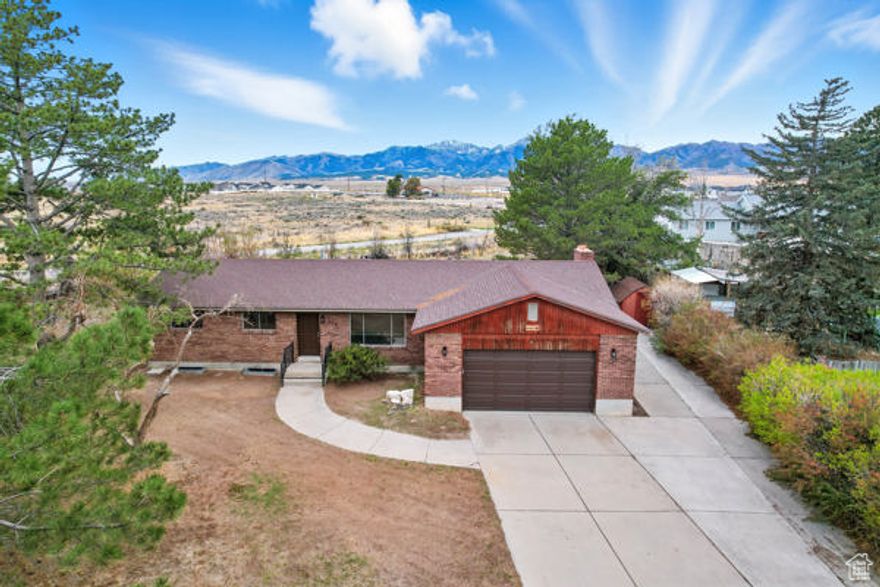 You'll love the mountain views from your private deck! Charming 2-Bedroom, 2-Bath Rambler in Grantsville with a Formal Living Room, Bright Open Gathering Space and Kitchen Area that's Ideal for Everyday Living and Entertaining. The Primary Suite includes a Private Bath and 2 closets, there is an additional Bedroom for Guests, Office, or Hobbies. Enjoy a Large Back Deck with Expansive Country Views. The Lower Level Provides another Family/Gathering Room with Wood Burning Stove, Storage Area, Office or Pantry w/Sink and Unfinished Space that Provides Excellent Potential for added Living Space or Storage. New HVAC System with 10 yr. warranty. Attached Garage, Ample Storage, and Peaceful yet Convenient Location make this Home a Must-See!