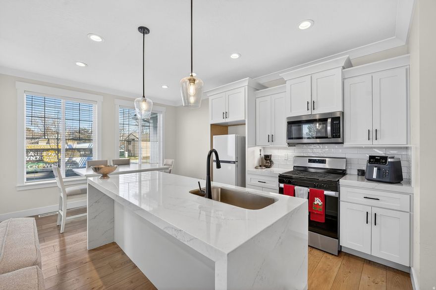 New construction townhome (2024) located in a central and highly convenient area of West Valley City. This home offers 3 bedrooms, 2.5 bathrooms, and 2,305 sq ft, featuring a full basement and an attached 2-car garage. The interior showcases quartz countertops, white craftsman cabinets, luxury vinyl plank flooring, and a modern, functional layout. Includes a covered patio and low-maintenance living with HOA covering exterior maintenance, water, trash, and snow removal. Excellent access to Bangerter Highway and I-215, with close proximity to shopping, dining, schools, and everyday amenities.