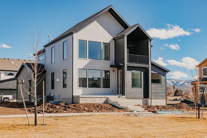 Welcome to Lot 267 in The Crossings-Heber's premier luxury community surrounded by breathtaking mountain views. This Glacier Rear Load Floor Plan offers elevated mountain living with 6 bedrooms, 4.5 bathrooms, and a fully finished basement across 4,478 sq ft, plus over $181,000 in upscale upgrades. The home shines with a gourmet kitchen featuring double ovens and quartz countertops, beautiful luxury vinyl flooring throughout, and dramatic 20-ft vaulted ceilings that fill the space with light and openness. Enjoy finished front and back landscaping and low-maintenance living-the HOA covers yard care for all areas not enclosed by fencing. Current amenities include a park, playground, and community fire pit, with future plans for a pool and clubhouse. Ideally located near shopping, two reservoirs within 15 minutes, and just 20 minutes from Park City, The Crossings is a high-class, sought-after destination for those who want both elegance and adventure close by. Home will be complete by Mid March 2026.