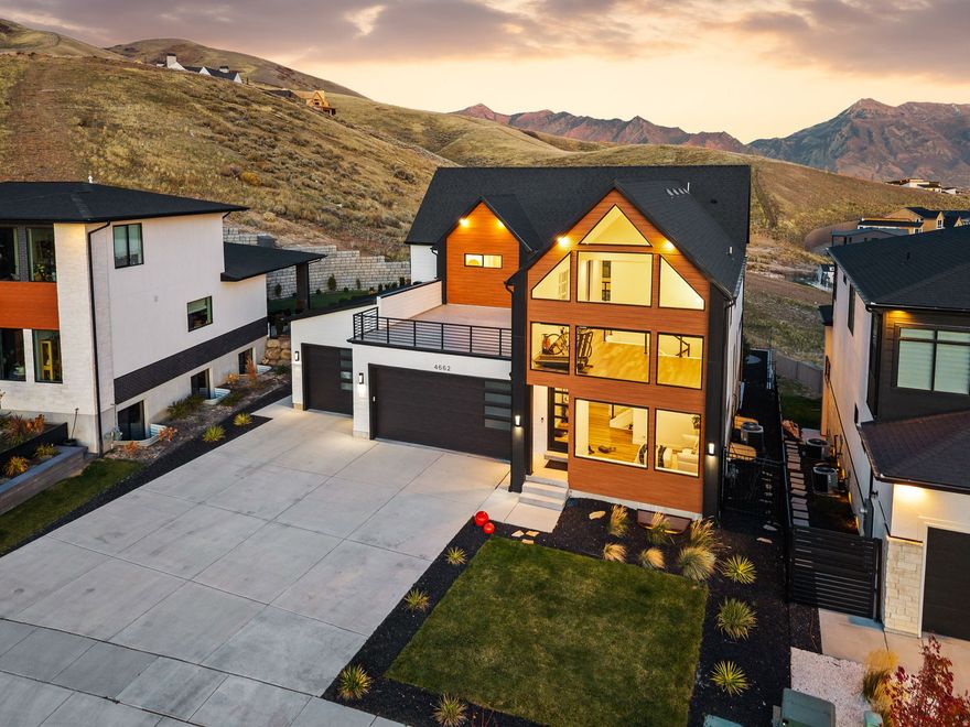 OPEN HOUSE SAT, DEC 6, 2:30-4:30. Modern mountain luxury with endless views - live above it all! Perched near the top of Traverse Mountain in a clean, quiet neighborhood in the heart of Utah's Silicon Slopes, your next home offers breathtaking views on both sides while breathing better above the inversion! With a future park planned directly in front, you'll forever appreciate seeing for miles. Enjoy a like-new home with the advantage of beautiful landscaping and window treatments  including automatic blinds on a nearly 30-foot wall of windows, showcasing the mountain with no backyard neighbors. Spend time outside on any of the five patio spaces, including the sunrise/sunset deck. Appreciate convenience? How about laundry rooms on every floor? Yes! Main floor primary suite? Yes! The front room could be formal living or a home office/den. The finished basement includes a full kitchen and separate walk-out entrance, ideal for a private mother-in-law apartment or guest suite. Experience a sense of seclusion while being just a few minutes from The Outlets, tons of shopping and restaurants, and I-15 and less than an hour from seven world class ski resorts, including Deer Valley, Park City, and Sundance. Make the most of the long list of amenities offered by the HOA, all with a low HOA fee, or get out on the miles of mountain trails to enjoy this magnificent lifestyle! Square footage from recent appraisal and other info provided as a courtesy. CLICK TOUR TO WATCH THE SHORT VIDEO. Buyer and buyer's agent to verify all.