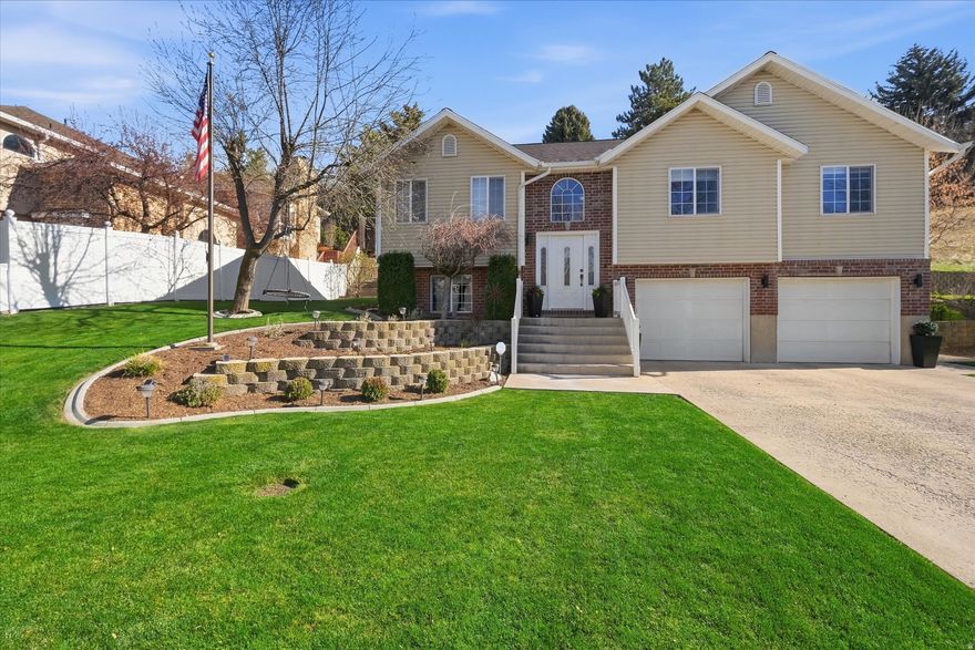 Nestled on the east bench, this beautifully updated home offers mountain access and city convenience. The open main floor features LVP flooring, stylish upgraded light fixtures, a cozy gas fireplace, and plenty of natural light throughout. With all appliances included, the move-in ready layout has four large bedrooms, two modern bathrooms, and two spacious living rooms, including a  wet bar on the lower level. The oversized garage has a dedicated gym area, ample storage, and space for two cars. Enjoy privacy and outdoor entertaining on the fully fenced backyard and large back patio.  Buyer to verify all information.