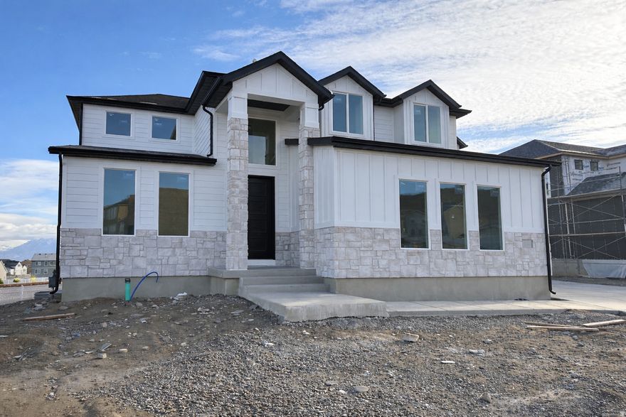 Lot 174 Brixton Park The Oquirrh. Home is nearing completion and could be completed in as little as 30 days! Standard features include a finished basement with ADU, walkout basement, large kitchen with gourmet appliance package, mudroom, designer laminate wood flooring, massive vaulted primary suite with great mountain views and more! Buyer to verify all info