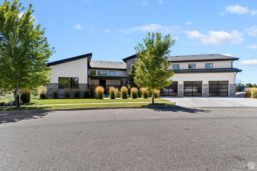 This stunning contemporary home in Mountain Green offers a perfect balance of luxury, comfort, and panoramic mountain views. Designed with clean lines and expansive windows, each room is filled with natural light and frames the beauty of the surrounding landscape.  The flexible floor plan includes five spacious bedrooms and a dedicated home theater, providing space for everyday living, remote work, or relaxing in style. Whether you're gathering with family or enjoying a quiet evening, the layout is designed to suit a variety of needs.  A vaulted great room features a striking stacked-stone fireplace and opens to a large deck perfect for taking in the fresh mountain air. The adjoining kitchen showcases two-tone cabinetry, bold patterned tile, quartz countertops, a large island, and elegant gold fixtures.  Just off the kitchen, the dining area is illuminated by a crystal chandelier and a wall of windows offering unobstructed views of rolling hills and rugged peaks. The seamless indoor-outdoor connection enhances the natural flow and atmosphere of the space.  Located just minutes from Snowbasin Resort, you'll enjoy easy access to world-class skiing, hiking, and year-round outdoor adventure-all within a peaceful, upscale Mountain Green neighborhood.  All property information, boundaries and documents to be verified by buyer.