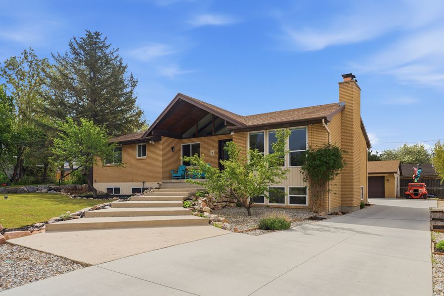 Nestled at the quiet end of a private cul-de-sac, this masterfully updated 5-bedroom, 3-bathroom residence offers a sophisticated blend of design and comfort in the heart of Millcreek. The open-concept main floor features a stunning chef's kitchen with granite countertops and custom cabinetry, flowing seamlessly into a light-filled great room with vaulted ceilings and elegant LVP wood flooring. From the serene primary suite to the fully finished walkout basement-complete with a cozy fireplace and three additional bedrooms-every inch of this home is designed for modern living. The outdoor spaces are equally impressive, featuring an expansive back deck that showcases breathtaking mountain views. The professionally landscaped yard serves as a private paradise with custom garden boxes, a stream nearby, and plenty of room for summer entertaining. Beyond the greenery, the property boasts a rare and massive detached 4-car garage and shop, providing a premier workspace for car enthusiasts, hobbyists, or those simply seeking abundant storage for adventure gear. Perfectly positioned just minutes from top-tier schools, local boutiques, and the vibrant energy of downtown, this home offers an unbeatable lifestyle upgrade. Whether you're hosting formal dinners in the elegant dining room or enjoying a quiet evening under the stars, this property delivers the ultimate Millcreek experience. It is a rare find that combines luxury, versatility, and a prime location in one exceptional package.