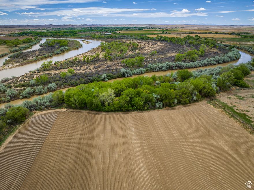 RIVERBEND VAST VISTA where the river meets possibilities with 72.63 acres of fertile, irrigated agricultural land along the banks of the iconic Green River. Backed by sweeping views of the Book Cliffs and nourished by nutrient-rich soil and included water shares, this rare property is ideal for farming, homesteading, or building a private riverside retreat. Located minutes from I-70 and the town of Green River, you're perfectly positioned to explore the heart of desert and red rock country. Within an hour's drive, reach the wonders of San Rafael Swell, Ruby Ranch Sand Dunes, Goblin Valley, Canyonlands, Arches, Moab, or the Colorado River. The possibilities here run as deep as the river itself.