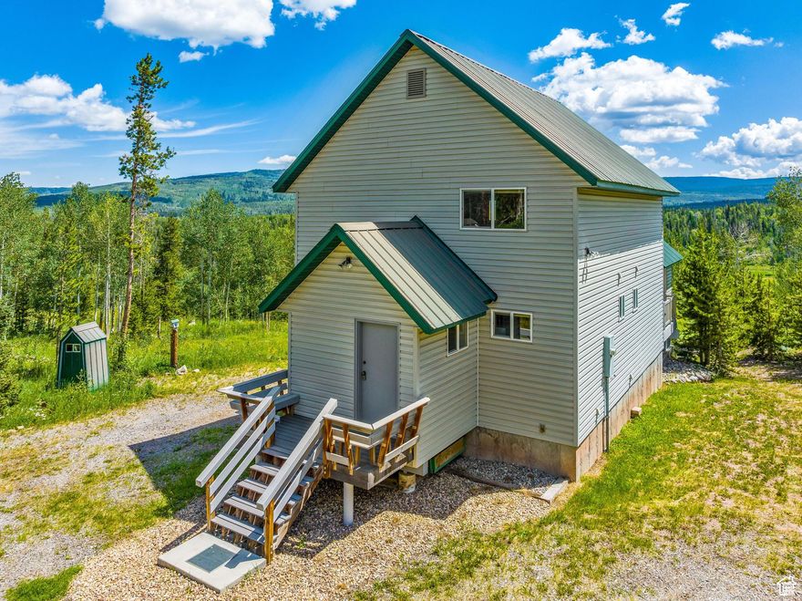 Welcome to your perfect year-round mountain escape. Tucked within the gated Uintalands community, this one-of-a-kind cabin offers the ideal blend of rustic charm and modern comfort. From the moment you step inside, you're greeted by soaring ceilings clad in floor-to-ceiling tongue-and-groove wood-sealed to perfection and radiating warmth. The main level features a spacious great room, a charming kitchen, and a cozy Primary Suite with its own en-suite bathroom. Upstairs, a lofted space overlooks the great room, giving you a front-row seat to everything from family game nights to quiet mornings by the fire. Step outside and let the fresh mountain air carry your worries away. Whether you're soaking in the views on the durable Trex deck or swapping stories around the fire pit, this secluded property is made for memory-making. Uintalands offers year-round access with a resident caretaker and a private pressurized water system that serves the entire cabin community-making both full-time living and weekend getaways seamless. Located just off Mirror Lake Highway and under 25 miles from Evanston, Wyoming. You'll also enjoy peace of mind and extra amenities nearby at the Bear River Ranger Station. Adventure awaits right outside your door with on-site hiking trails, a fishing pond, archery/shooting ranges, and picnic areas. No need for the fun to end when the snow flies! There are still plenty of options by hopping on your snow-cat or snowmobile. Fill up your day with by  exploring hundreds of miles of pristine snowy trails. Uintalands even has dedicated parking for snowmobile trailers. This is more than a cabin, it's a lifestyle and one you will truly never want to leave.