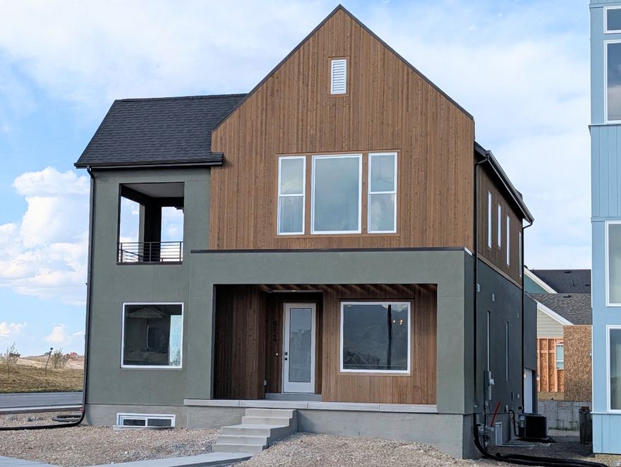 Brand New Corner Lot Home with a brand-new wood exterior! Amazing views of the New Watercourse from the hot tub-ready balcony in this popular Adventurer floor plan! Impressive designer upgrades such as: 9-foot ceilings on all levels, A fireplace, modern railing, coveted indoor/outdoor living layout with oversized sliding glass doors connecting the Great Room and Kitchen with outdoor patio space. The main-level office is filled with natural light thanks to abundant windows perfect for work or relaxation. Upstairs, the dreamy Primary Suite features its own covered, hot tub-ready balcony, along with a luxurious en-suite bathroom complete with a stand-alone soaking tub and a spacious walk-in shower. Estimated completion: May 2026. Photos are of actual home under construction.