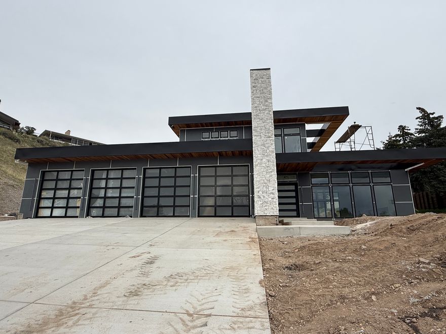 This home is nearing completion. Schedule an appointment to see it beforehand to allow the builder to complete changes for your needs. Discover elevated modern living in this extraordinary custom estate, a celebrated architectural design originally recognized as Canada's #1 home in 2017 and now thoughtfully reimagined in one of Salt Lake City's most coveted neighborhoods. Set on a private one-acre lot within a newly developed cul-de-sac near the top of Virginia Street, the property captures sweeping, unobstructed views of the Salt Lake Valley.  Designed for today's lifestyle, the open-concept floor plan is anchored by expansive floor-to-ceiling windows that create a seamless connection between indoor and outdoor spaces while flooding the home with natural light. The main living areas flow effortlessly, offering both functionality and architectural impact.  The great room showcases a chef-inspired kitchen with Subzero and THOR appliances and generous family space, finished with custom cabinetry and refined millwork-ideal for entertaining or everyday living. A dramatic floating staircase leads to spacious bedroom suites and rooftop patios designed to take full advantage of the home's elevated setting. The lower level is dedicated to leisure and retreat, featuring a private swim spa, home theater room and a sophisticated lounge with full bar.  Private showings are available by appointment.