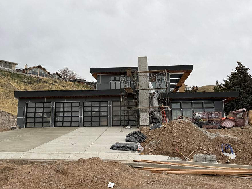 Completion is anticipated within the next 60 days!   Discover elevated modern living in this extraordinary custom estate, a celebrated architectural design originally recognized as Canada's #1 home in 2017 and now thoughtfully reimagined in one of Salt Lake City's most coveted neighborhoods. Set on a private one-acre lot within a newly developed cul-de-sac near the top of Virginia Street, the property captures sweeping, unobstructed views of the Salt Lake Valley.  Designed for today's lifestyle, the open-concept floor plan is anchored by expansive floor-to-ceiling windows and oversized sliding glass doors that create a seamless connection between indoor and outdoor spaces while flooding the home with natural light. The main living areas flow effortlessly, offering both functionality and architectural impact.  The great room showcases a chef-inspired kitchen and generous family space, finished with custom cabinetry and refined millwork-ideal for entertaining or everyday living. A dramatic floating staircase leads to spacious bedroom suites and rooftop patios designed to take full advantage of the home's elevated setting. The lower level is dedicated to leisure and retreat, featuring a private swim spa, sauna, home theater, and a sophisticated lounge with full bar.  Private showings are available by appointment-contact the listing agent for an exclusive preview of this remarkable estate currently under construction.