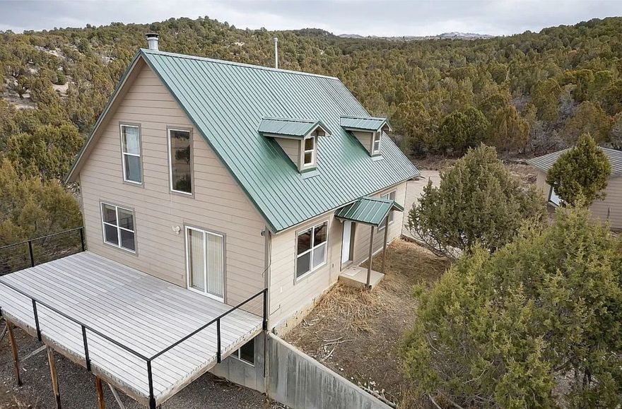 Escape to your own private mountain retreat in Freedom Ranch, a gated community just 10 minutes from downtown Mount Pleasant. This 2,419 sq ft cabin offers the perfect blend of remote, self-reliant living and everyday convenience, with room to work, play, and truly unwind.    Inside, the main floor features an open-concept kitchen and living room, a convenient laundry room, and a main-floor master bedroom. A large loft overlooks the great room and adds flexible space for guests, hobbies, or a cozy reading area. The daylight basement includes two additional bedrooms, a dedicated room that's perfect for a home office, a comfortable family room, and a large storage room for gear and supplies.    Set on 5.9 acres at the foot of the mountains, the property is surrounded by trees and long-range views in every direction-deer and elk are frequent visitors right outside your windows. The home is heated and cooled by an efficient split system on each floor, and a wood/coal-burning stove in the living room can easily heat the main level and loft for classic cabin comfort. Washer, dryer, and refrigerator are included, so you can move in and start enjoying the space right away.    For those interested in off-grid or backup capability, the property offers a solar energy system with 18 solar panels, inverter, and batteries, available for an additional $20,000. The community well is backed by solar power, providing added peace of mind that water remains available even if the grid goes down. A 20' x 30' garage and a 28' x 40' shop provide ample covered parking, storage, and workspace (all items pictured in the shop and garage are excluded from the sale).    Whether you're looking for a full-time residence, a secure mountain getaway, or a base for remote work and recreation, this Freedom Ranch cabin delivers privacy, safety, and the potential for a truly independent lifestyle-without sacrificing quick access to town amenities. Contact Owner directly with any questions.