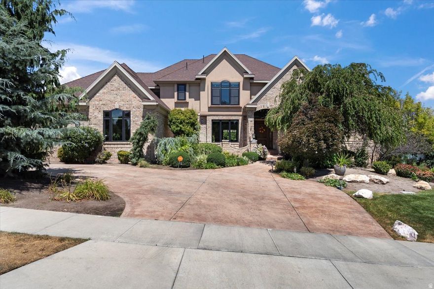 Completely updated and move-in ready, this exceptional custom estate in the highly desirable Parkway Palisades offers luxury, comfort, and true resort-style living. The home has been thoughtfully refreshed throughout with high-end finishes, designer details, and brand-new windows that fill the space with natural light. A grand vaulted foyer welcomes you with a sweeping spiral staircase and open overlook, setting the tone for the home's refined style and craftsmanship. The two-story great room features a striking stone fireplace wall and a custom retractable glass door system that creates seamless indoor and outdoor living.The backyard is a private retreat featuring a resort-style pool and spa with waterfalls, beach entry, slide, LED lighting, and firepit, all surrounded by mature landscaping. A large Trex deck spans the rear of the home, ideal for entertaining and relaxing evenings.The main-level owner's suite offers a true retreat with a fireside sitting area and a spa-inspired bathroom complete with a freestanding tub, walk-in shower with voice-activated controls, makeup vanity, and a custom walk-in closet with private laundry. The chef's kitchen combines beauty and function with handcrafted cabinetry, Thermador appliances, a butler's pantry, and a unique island table for casual dining. A formal dining room with its own fireplace adds warmth and elegance. The fully finished lower level expands the living space with a second full kitchen, family room, theater with built-in seating, fitness room, additional bedrooms, bathroom, and private walk-out access. This rare opportunity offers timeless luxury, modern updates, and an unmatched lifestyle in one of the area's most sought-after communities.Square footage figures are provided as a courtesy estimate only and were obtained from appraisal.  Buyer is advised to obtain an independent measurement.