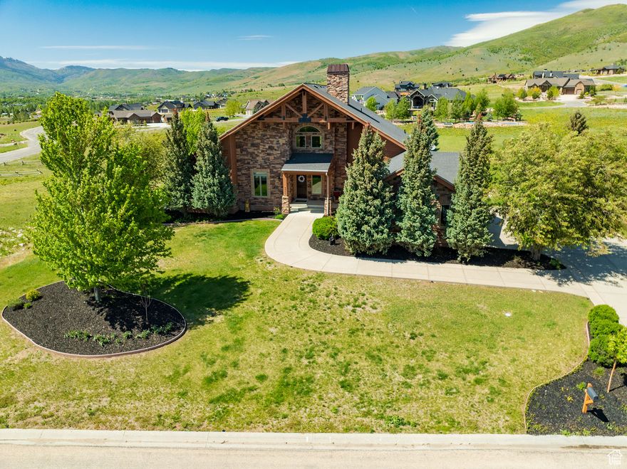 Beautiful custom-built home in the quiet Eagle Ridge neighborhood located just below Powder Mountain. The perfect spot for easy access to the outdoors, with nearby biking trails, local grocery stores, and restaurants. The community has preserved open spaces with wildlife and rustic fencing.  4,700 sq ft of living space, including 5 bedrooms, 3.5 bathrooms - of which 3 were recently renovated, and two fireplaces. The main level features an open layout with 24-foot ceilings, exposed timber beams, and large windows that bring in plenty of natural light. The kitchen is built for entertaining, and there's a second kitchenette in the basement for added convenience. Two family rooms and extra seating areas offer flexible living space. The basement gym can be used as another living area or converted into an ADU with minimal changes. The primary suite includes vaulted ceilings, new windows, and direct access to a large deck that overlooks a landscaped backyard with mature trees, flowers, and open space. Outside, there's a firepit and hot tub for relaxing. Recent upgrades include a whole-home generator, tankless water heaters, new carpet and paint (2023), furnace and A/C less than 10 and 5 years old respectively.