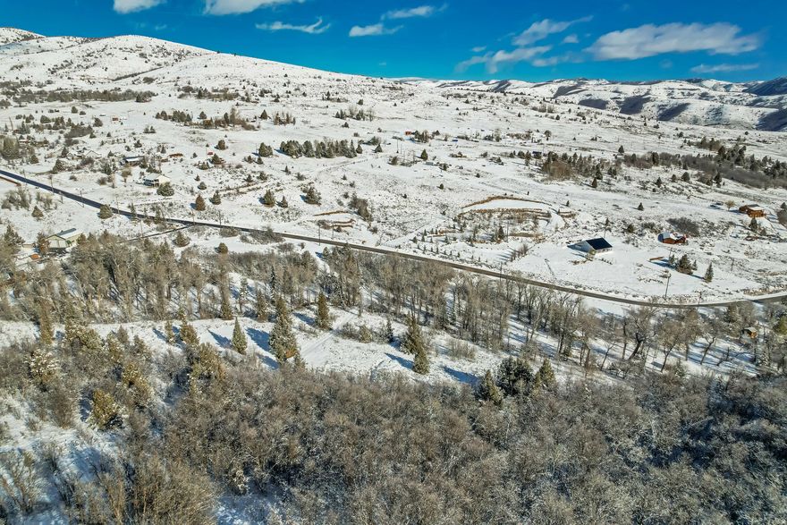 High-Mountain Sanctuary: 2.71 Acres with Seasonal Creek & Wasatch Views. Escape the valley heat and noise to this stunning 2.71-acre retreat in Evergreen Park. Perched at 7,000 feet on the back side of the Wasatch Front, this property offers a rare combination of Alpine beauty and total privacy. A seasonal creek meanders through the lot, complemented by mature trees. Located just 11 miles from the heart of Huntsville, you are perfectly positioned for year-round adventure. Enjoy world-class skiing at three nearby resorts, or spend summer afternoons at Causey and Pineview Reservoirs. This is an outdoor enthusiast's playground, with immediate access to hiking, RZR riding, and snowmobiling right from your door. With no HOA restrictions and easy access off the plowed main Evergreen loop, this is the freedom you've been looking for. Bring your vision of a high-altitude retreat to life in one of Utah's most breathtaking landscapes.