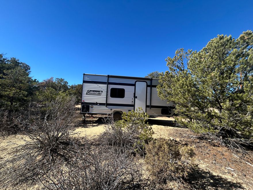 Discover your perfect getaway or future homesite with this 1.02-acre parcel offering year-round access and the ideal blend of comfort and opportunity! This beautiful lot has already been professionally surveyed and includes power located right at the property line (buyer to pay connection fees). Adding incredible value, the sale includes a brand-new 2025, 17-foot Coleman camp trailer all ready for you to start enjoying your land immediately! Whether you're planning a weekend retreat, a seasonal escape, or your future home base, this property provides the flexibility and setup you need. Enjoy the peace and privacy of country living with easy access in every season. Bring your outdoor toys, your building plans, or simply relax in your new Coleman trailer while you dream big. Don't miss this ready-to-go parcel with electric nearby and endless potential!