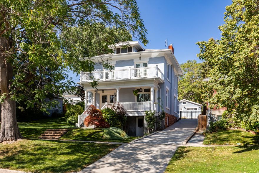 An iconic Avenues residence, this stately 2-story Four Square blends timeless architecture with modern sophistication. A stunning entryway with a graceful double staircase opens to elegant formal living and dining spaces, rich Brazilian cherry flooring, and a beautifully updated kitchen that flows seamlessly into an expansive great room addition, complete with heated floors, perfect for gathering and entertaining. The oversized primary suite is a true retreat, featuring a spacious walk-in closet, a luxurious bath, and direct access to the back balcony overlooking the lush backyard. A fabulous sitting porch, paired with a front balcony, extends the living spaces outdoors. Rare for The Avenues neighborhood, the .30-acre lot offers garden space, a beautiful paved patio, an oversized two-car insulated garage, RV parking, and ample room to design your dream outdoor retreat. The lower-level apartment offers flexible living, ideal as a rental or easily reincorporated into the main home. All within steps of downtown, City Creek Canyon, Memory Grove, shopping, dining, and the vibrant Avenues lifestyle.  This house might just have it all. The home can be sold furnished, excluding some personal items.