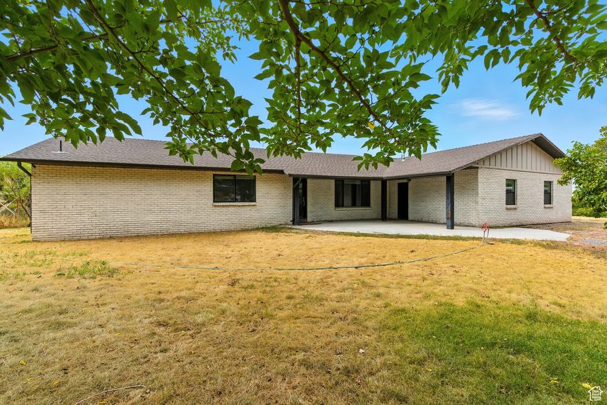 UNIQUE PROPERTY!! Welcome to this beautifully remodeled all-brick home nestled on 2.5 acres along SR-198 in Santaquin. Blending timeless craftsmanship with thoughtful modern upgrades, this spacious 4-bedroom residence offers just over 4,000  sq. ft. of comfortable living.  The heart of the home showcases a stunning kitchen with sleek quartz countertops, while a cozy gas fireplace adds warmth and charm to the living space. A brand-new primary suite provides a private retreat, complete with modern finishes and a spa-like feel for ultimate relaxation. Outside, the expansive 2.5-acre lot invites endless possibilities-gardens, recreation, or expansion-making it ideal for those who value both space and opportunities. The property is also equipped with its own well and septic system, offering self-sufficiency. With durable brick construction, fresh renovations, and an ideal blend of comfort, style, and practicality, this Santaquin gem is ready to welcome its next chapter.
